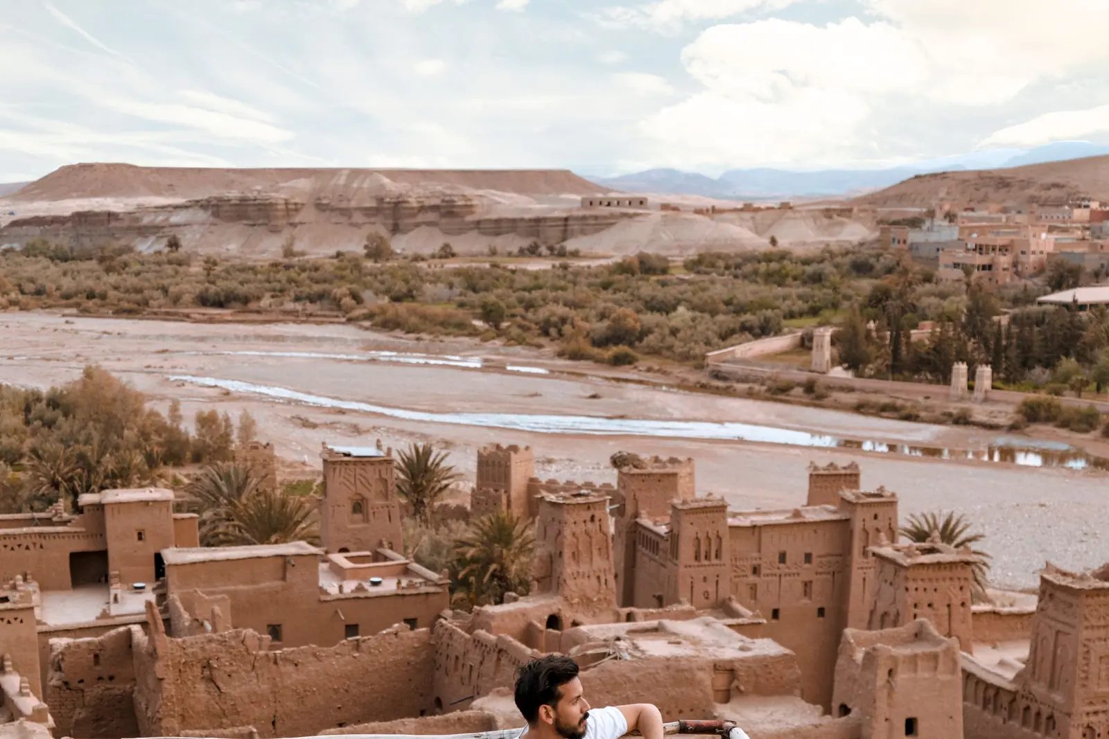 Terrace with cushions facing an earthen kasbah, Morocco
